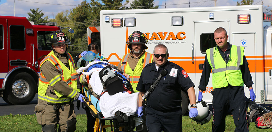 NAVAC clinicians and partners moving a patient