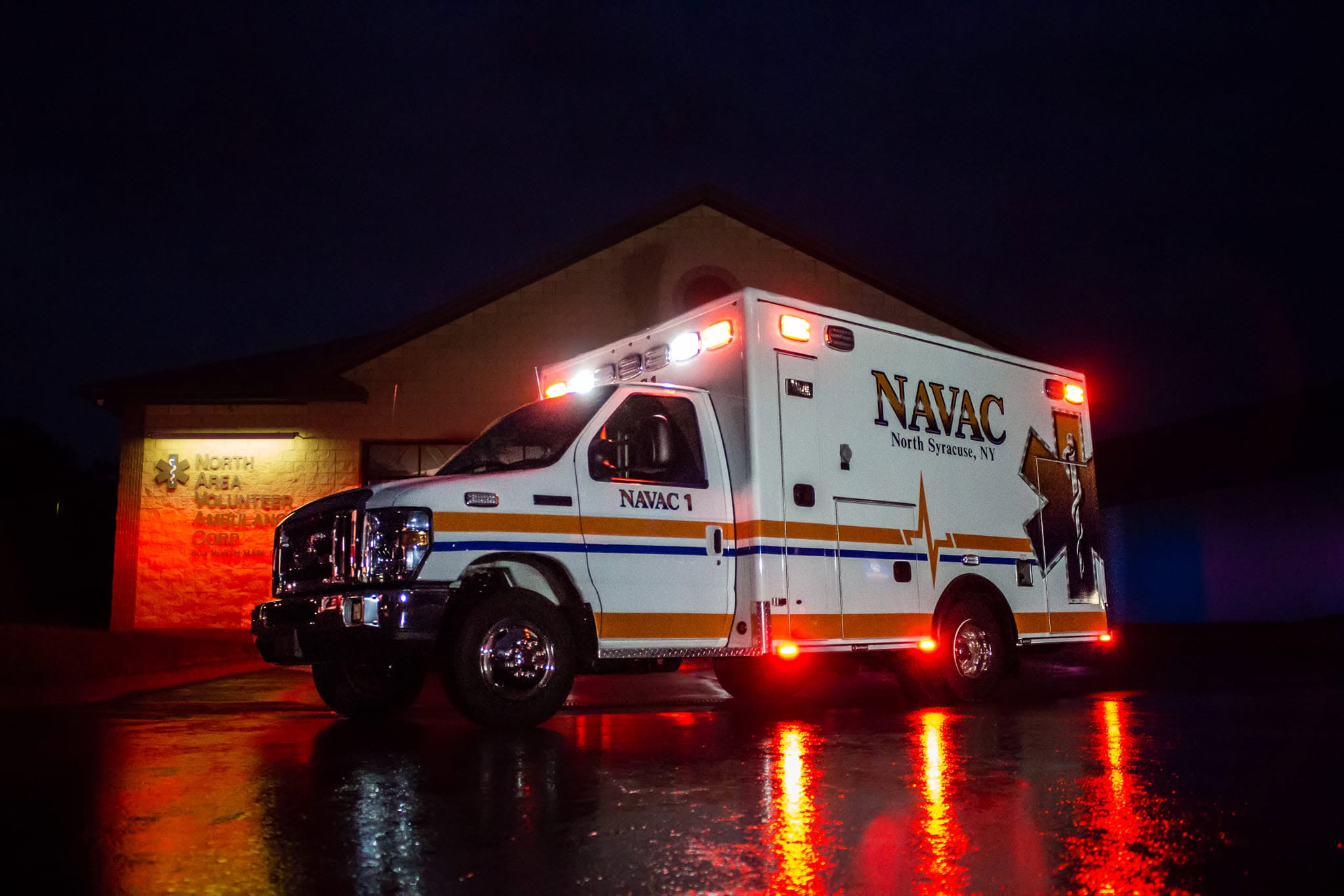 NAVAC ambulance at night with emergency lights